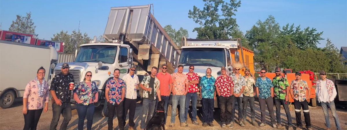 Members of the Quality Turf construction crew posed in front of their construction equipment.