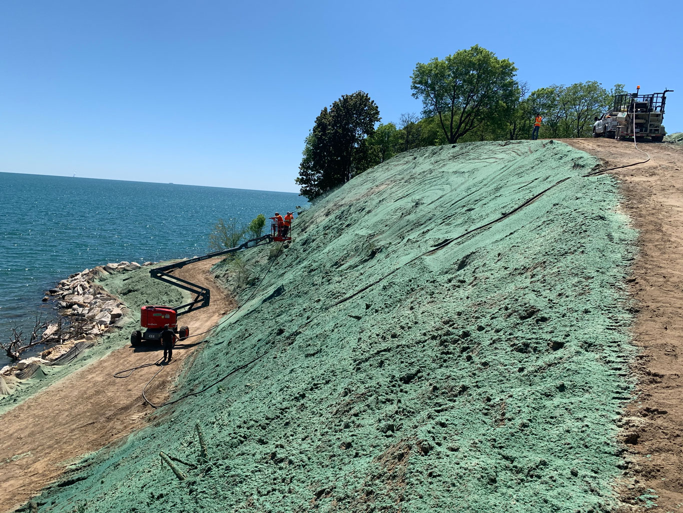 Professional Bonded Fiber Matrix (BFM) application for steep slope erosion control on an Oxley Bluff.