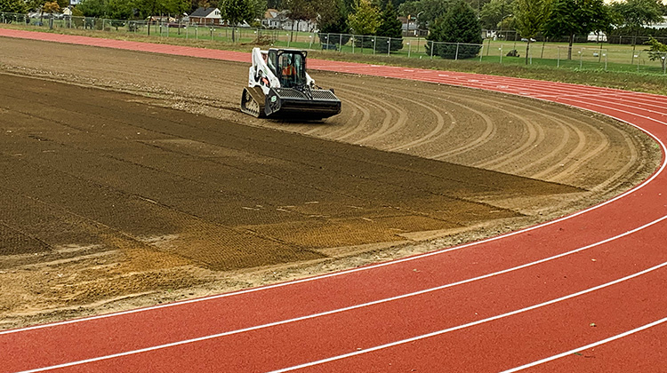 Fine grading and precision stone raking at Leamington District High School Sports field in Essex County.