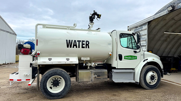 Commercial Quality Turf's water truck used for transporting water to landscaping and construction sites.